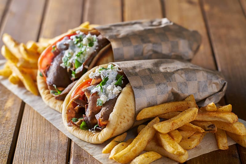 Freshly wrapped gyros with golden fries